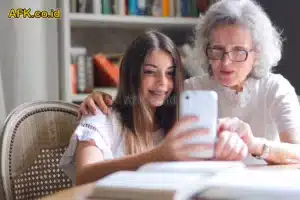 Nenek dan cucuk perempuan bermain handphone di kamar