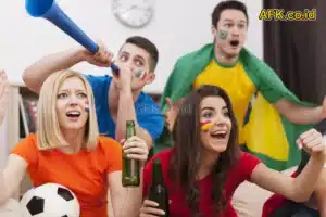 4 orang memakai baju dari beda negara menonton pertandingan sepak bola