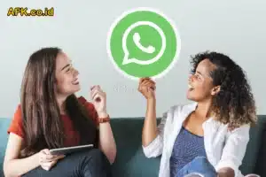 2 orang perempuan bahagia duduk di sofa dengan logo whatsapp besar