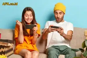 Pasangan duduk diatas sofa dan bermain game seru